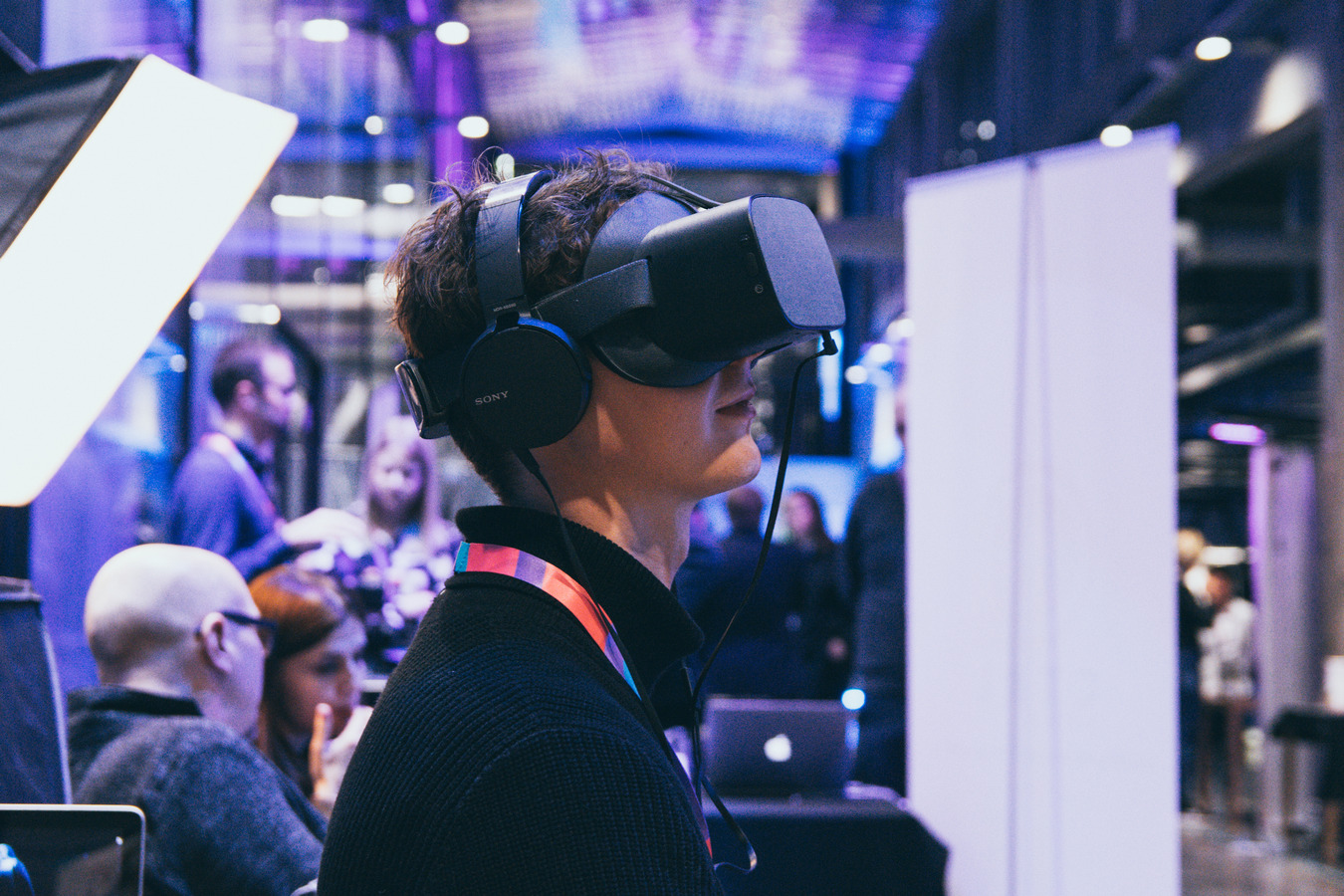 A person trying out virtual reality glasses.