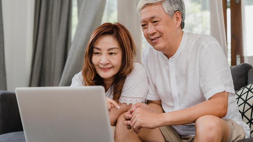 Asian parents using laptop together